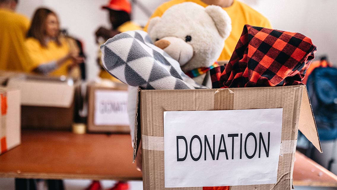 a person carries a box of donations