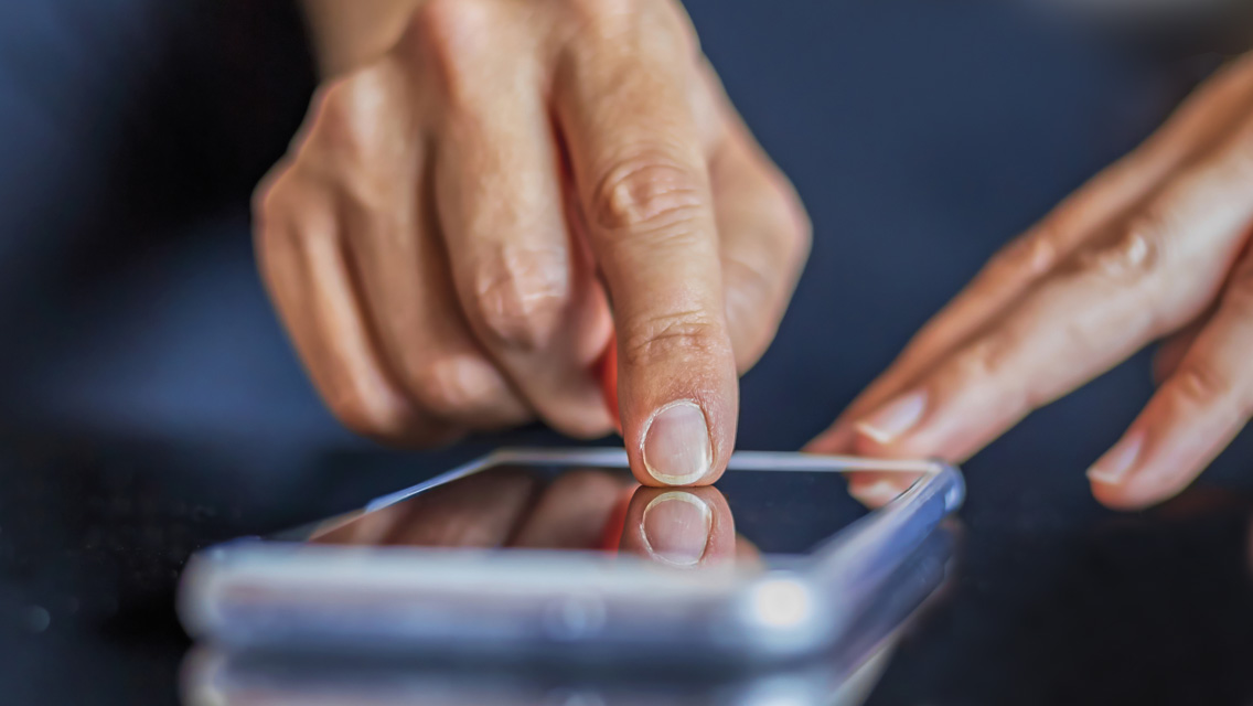 hands touch a phone screen