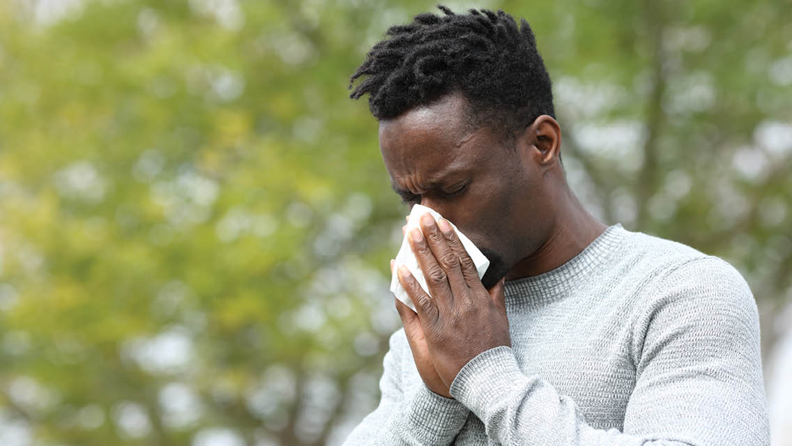 a man blows his nose
