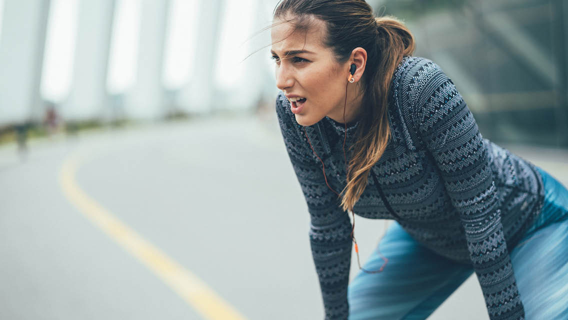 a woman breathing heavily after working out