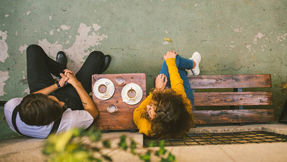 Two people enjoying coffee at cafe