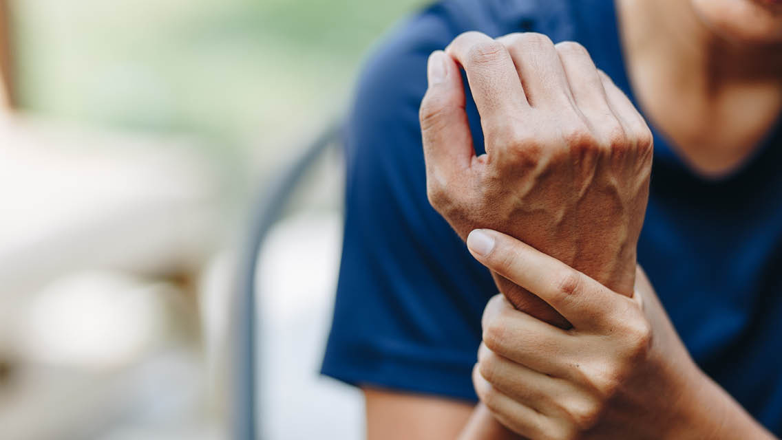 a person gripping their wrist