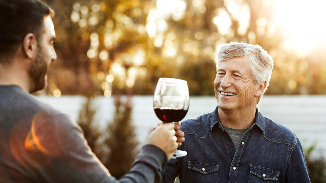 a man with silver toasts with wine