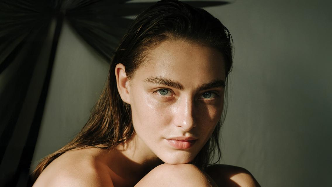 Person with face resting on their knee