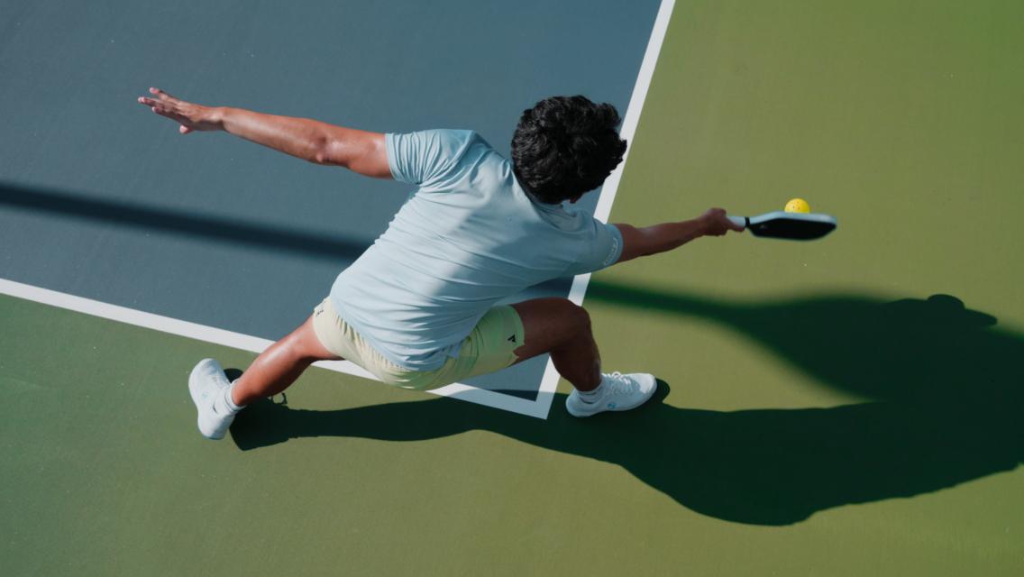 man hitting pickleball