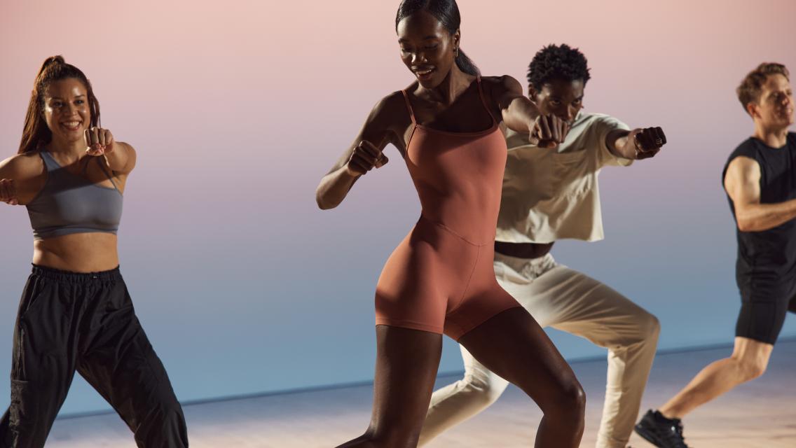 Four people exercising in a dance class at Life Time