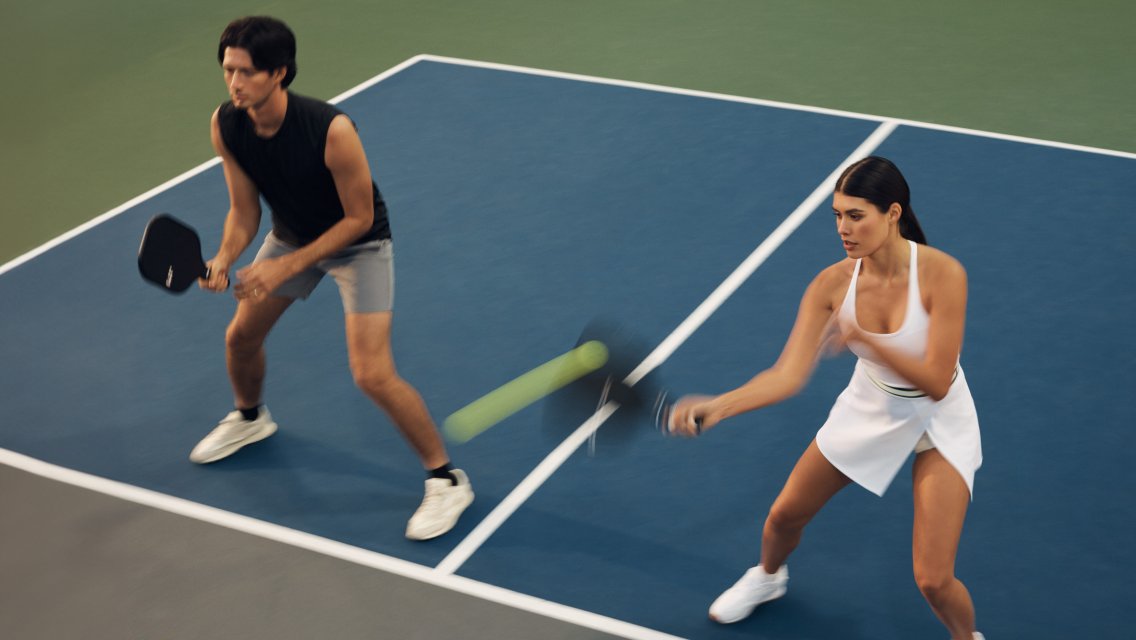 man and woman playing pickleball