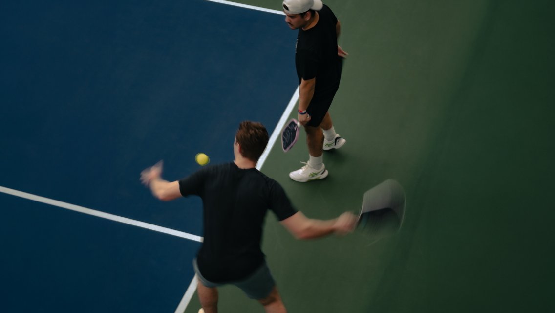 Two people playing pickleball