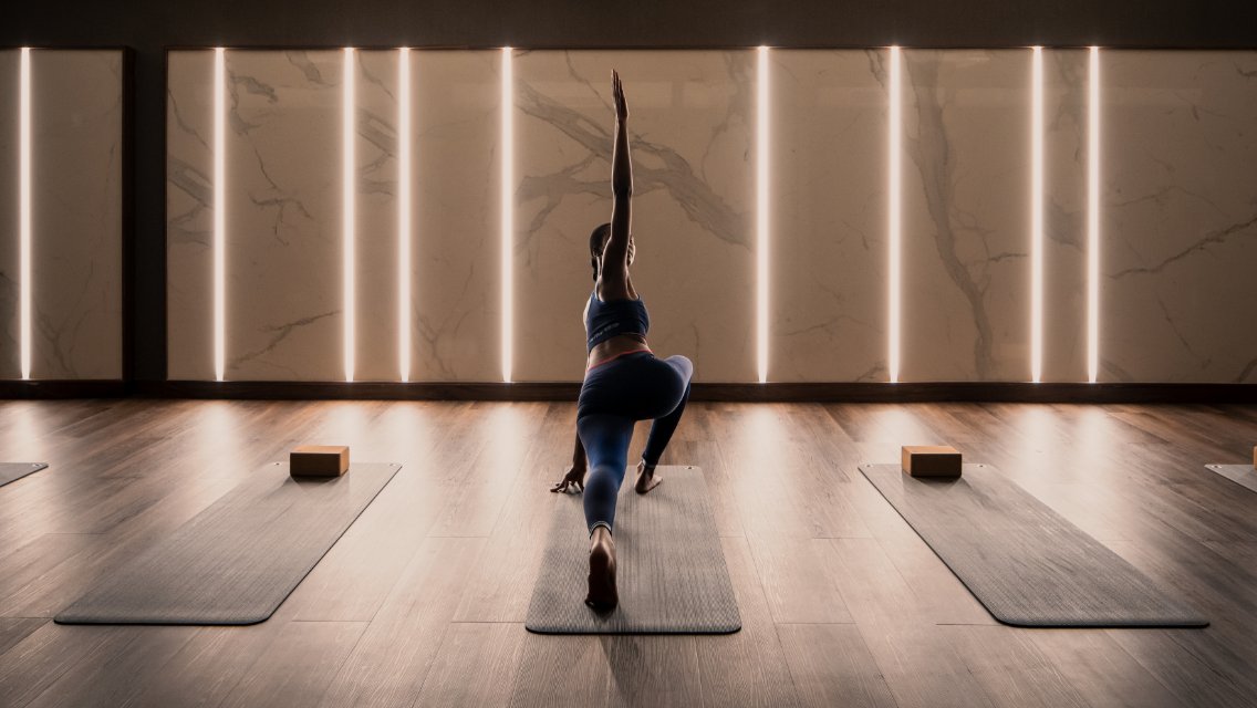 Person on a yoga mat in a yoga studio