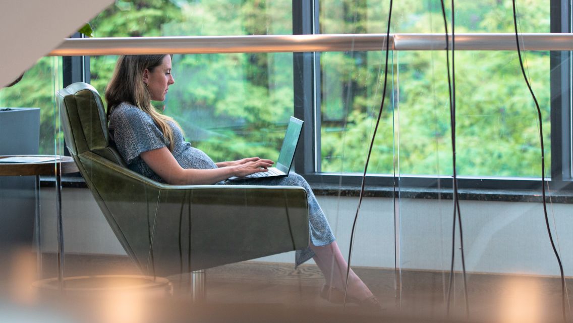woman working on her computer sitting in chair