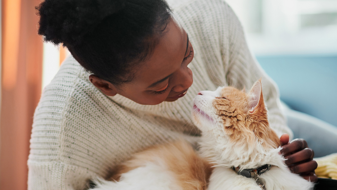 a woman and her cat snuggle