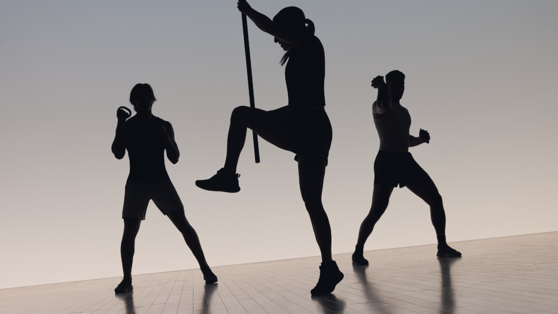 Three people taking a kickboxing class at Life Time
