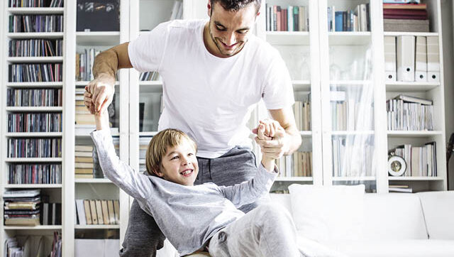 Dad and son playing on exercise ball