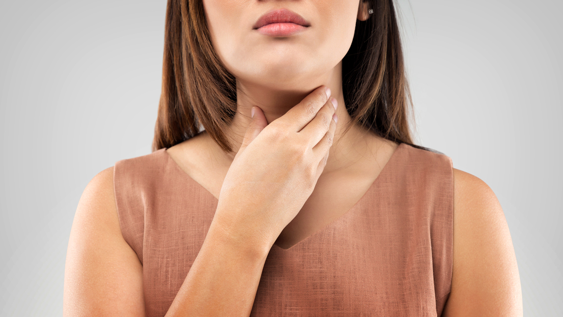 woman touching her neck