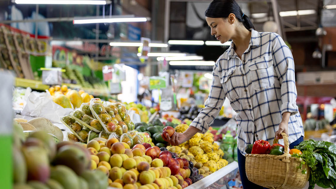 a woman grocery shops at an international market