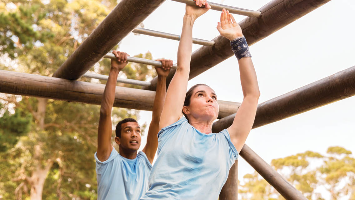 people crossing monkey bars
