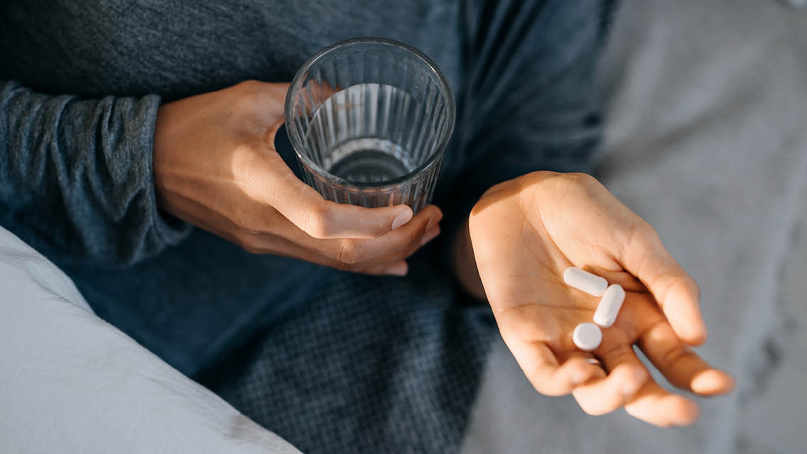 a person prepares to take melatonin supplments