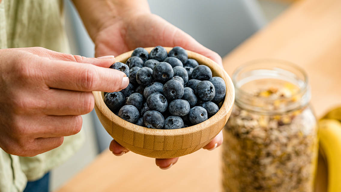 a person eating blueberries