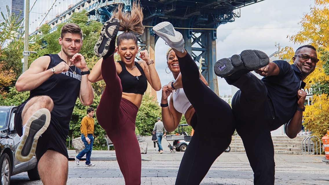 a group of Life Time performs kick