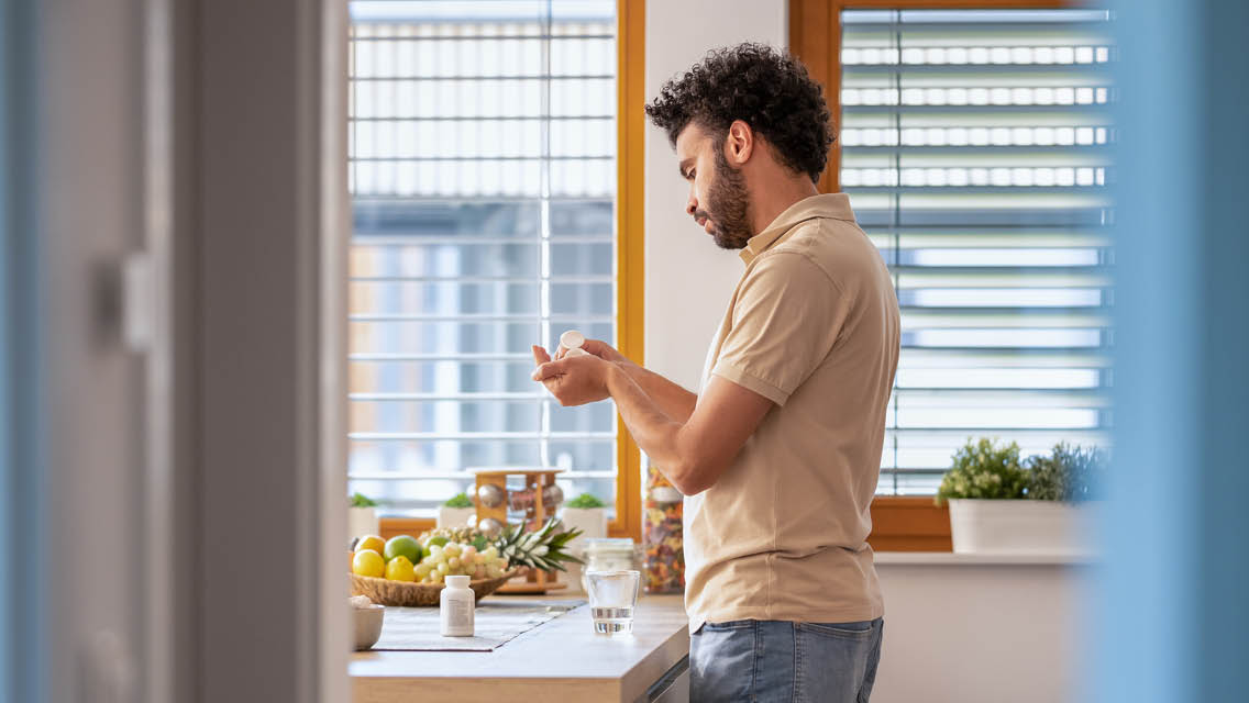 a man takes some vitamins