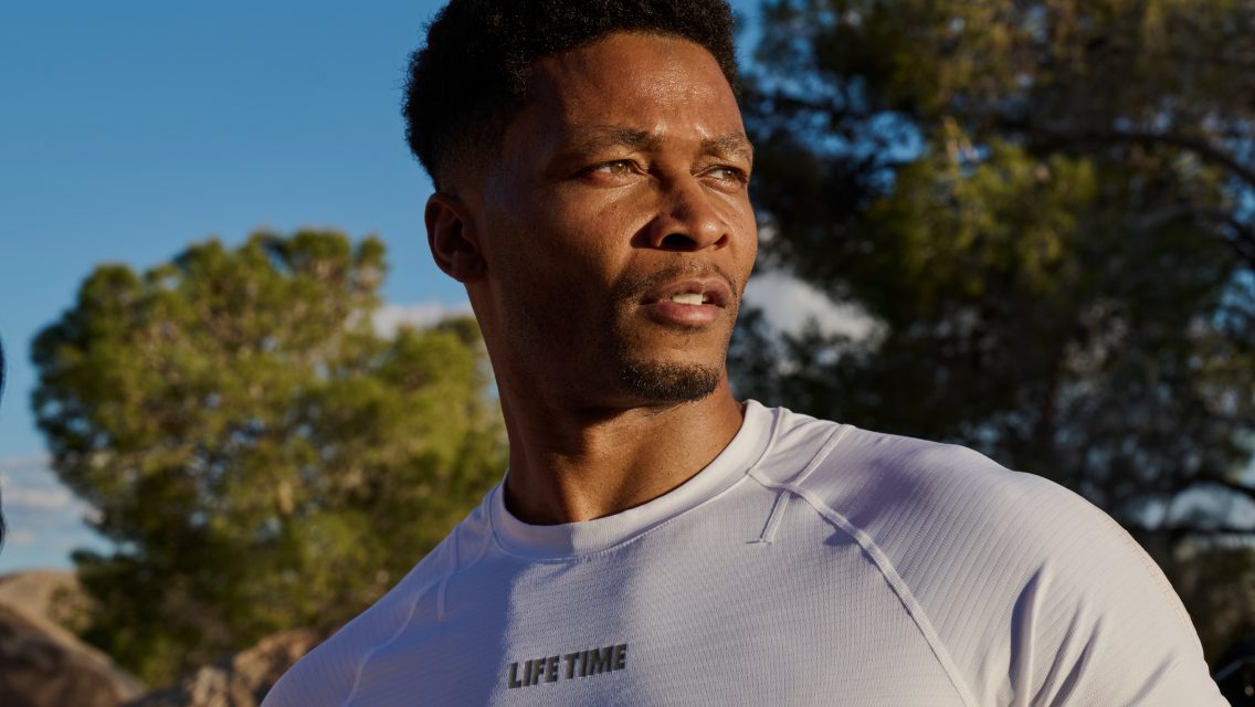 A man outside wearing a Life Time apparel shirt.