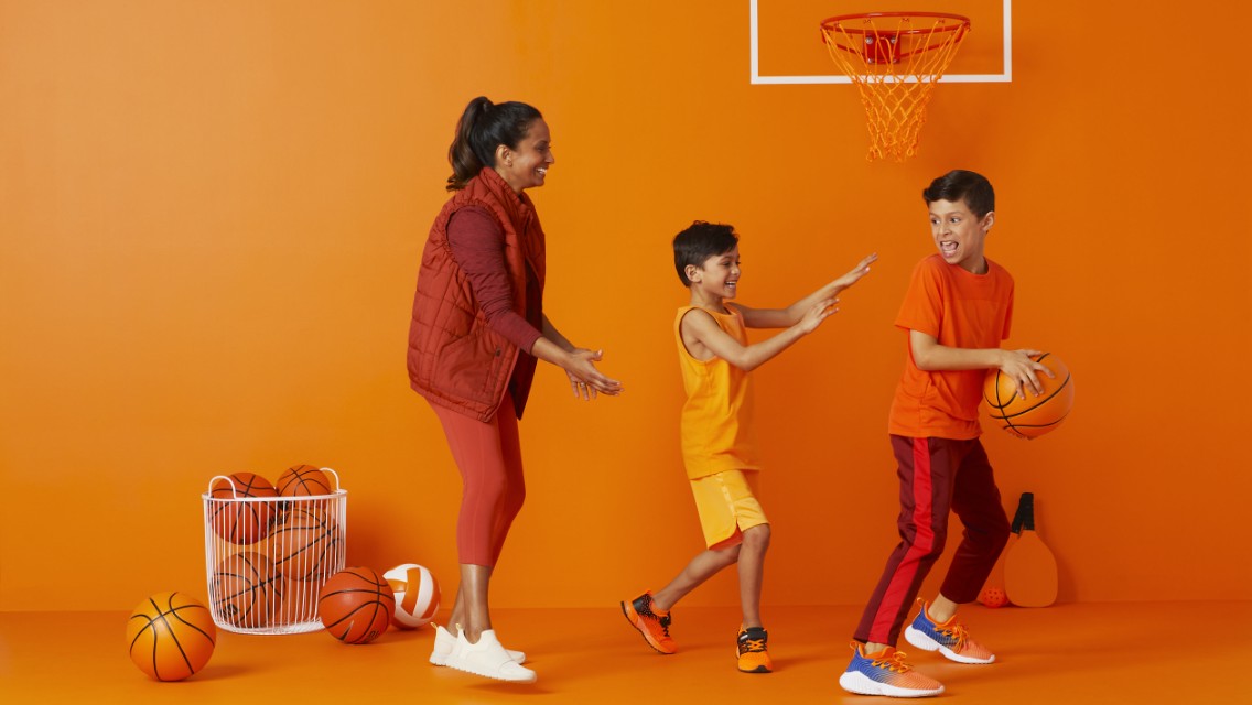 Three kids playing basketball