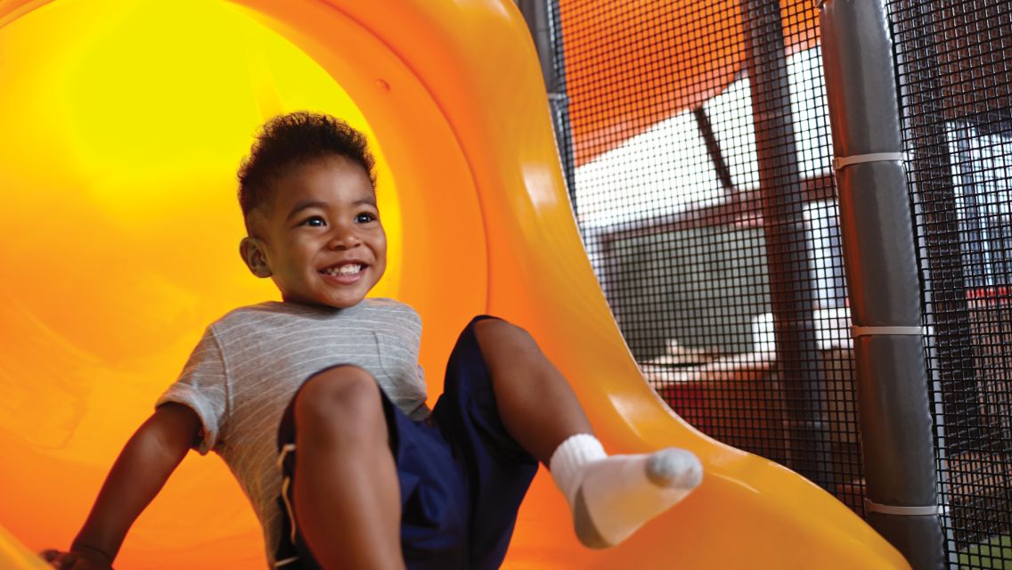 Kid going down slide