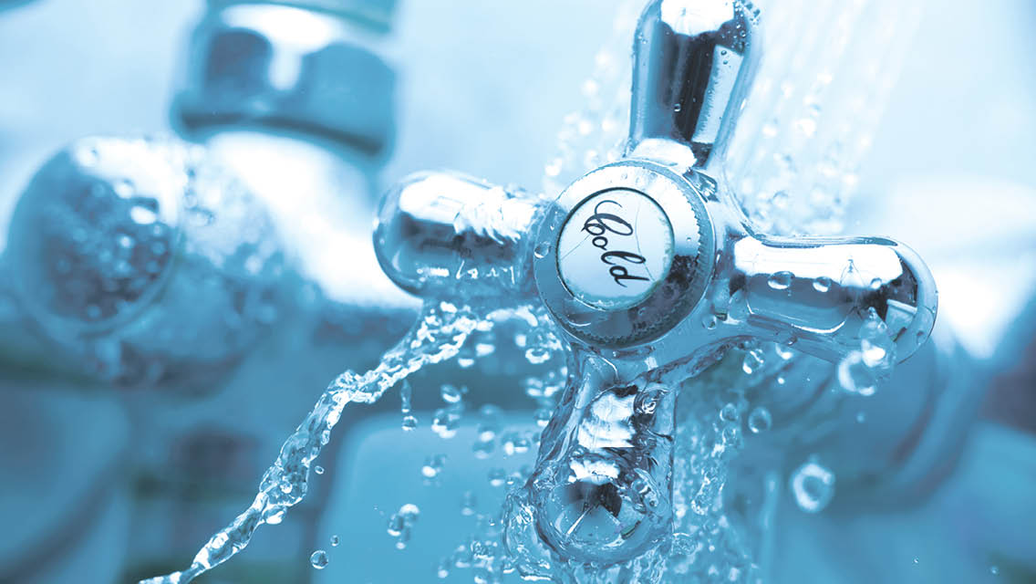 water splashes over a cold faucet handle