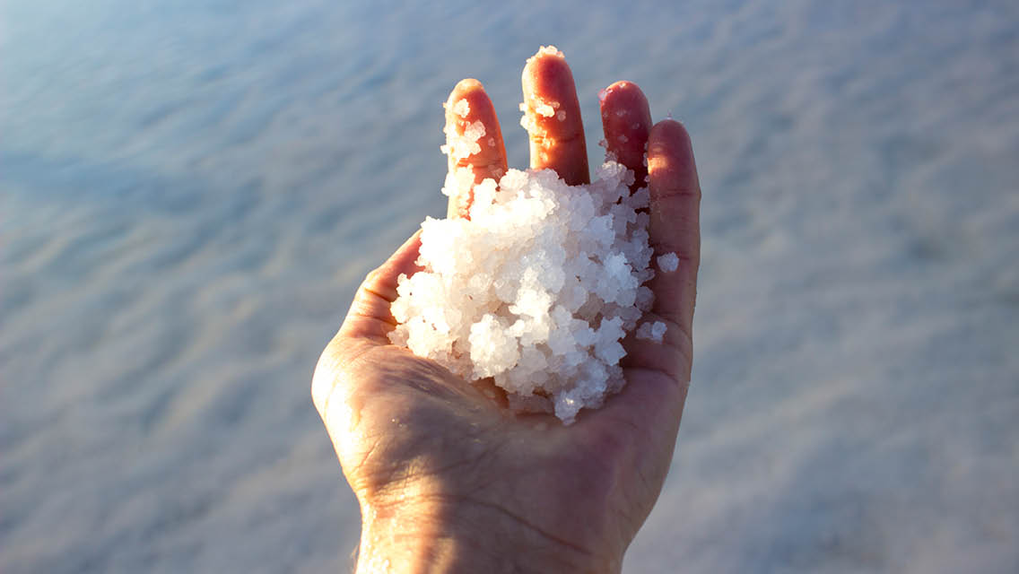a hand filled with natural salt
