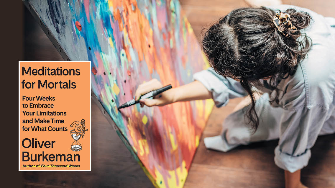 a woman paints while sitting on the floor