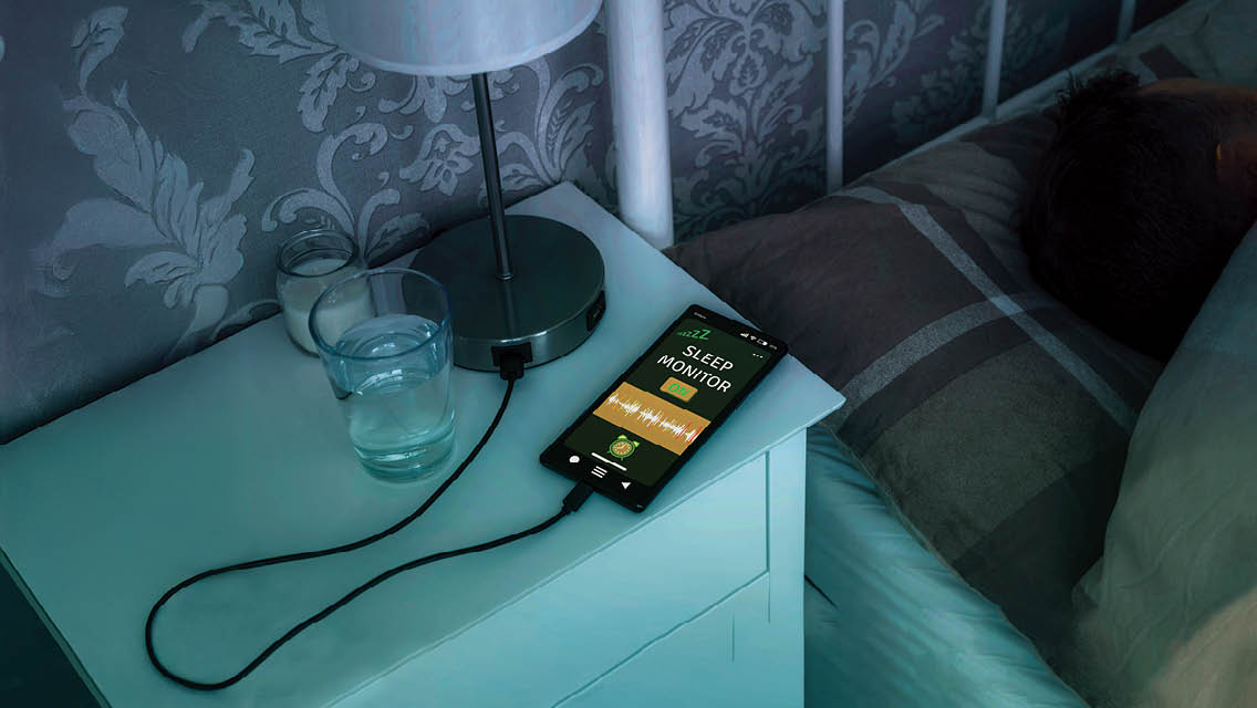 nightstand with phone plugged in tracking sleep patterns