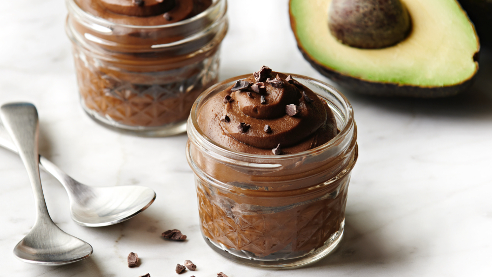 Cup of chocolate avocado mousse on a table.
