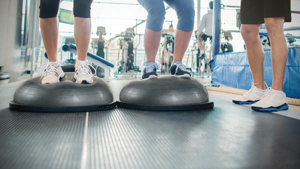 people standing on a bosu