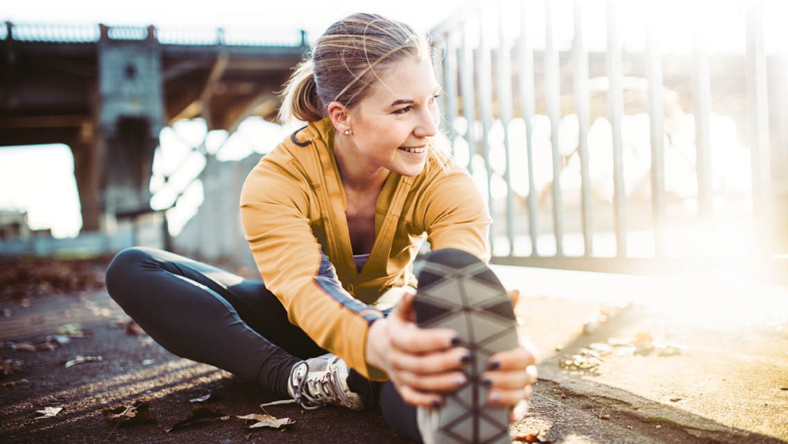a woman stretches outside