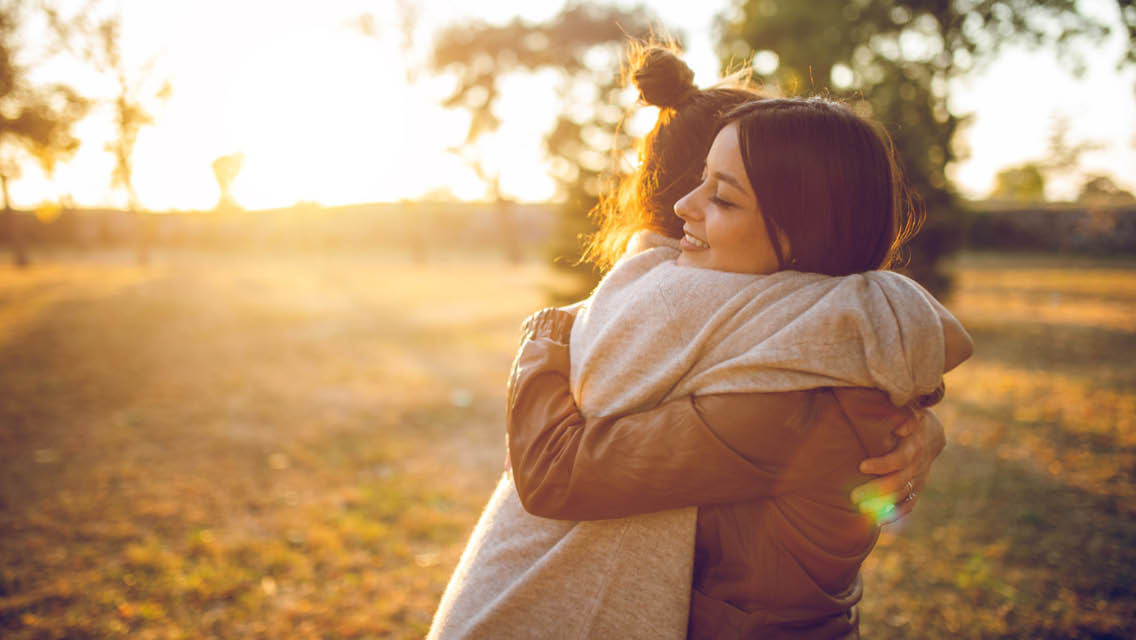 two women hug