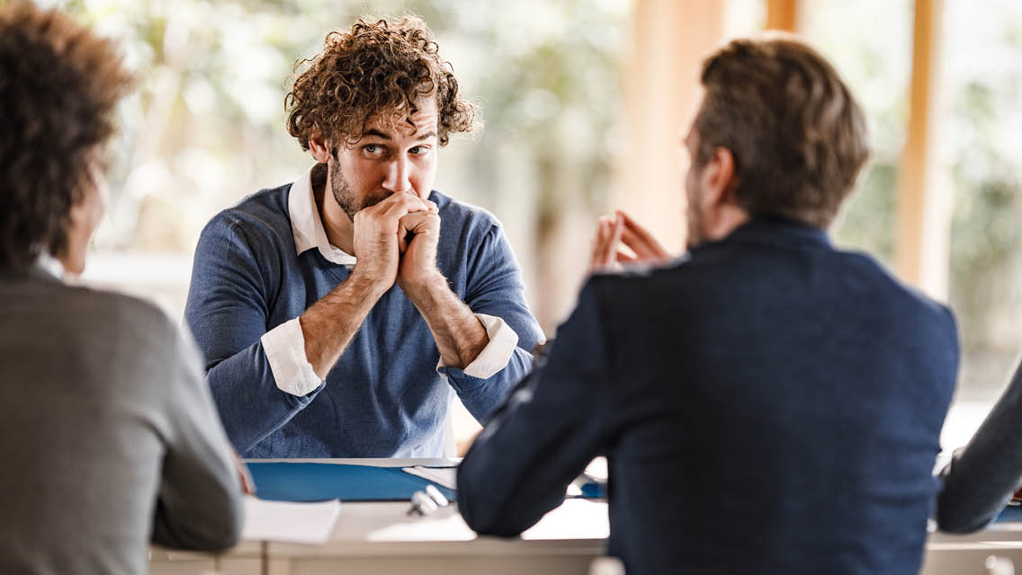 a person looks nervous while talking to people