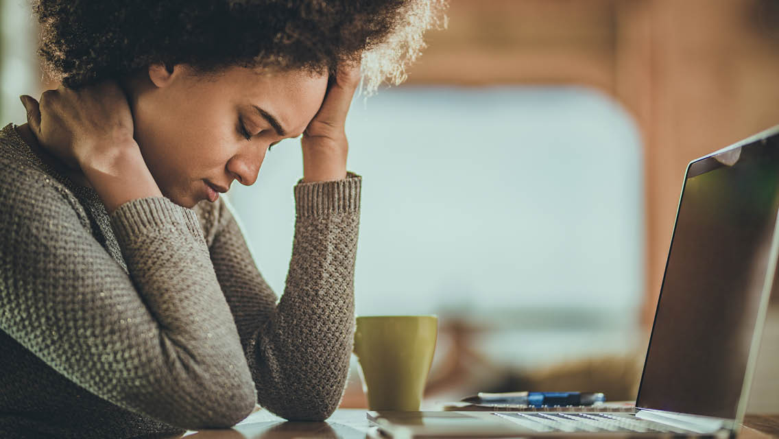 a woman works but appears to be in pain
