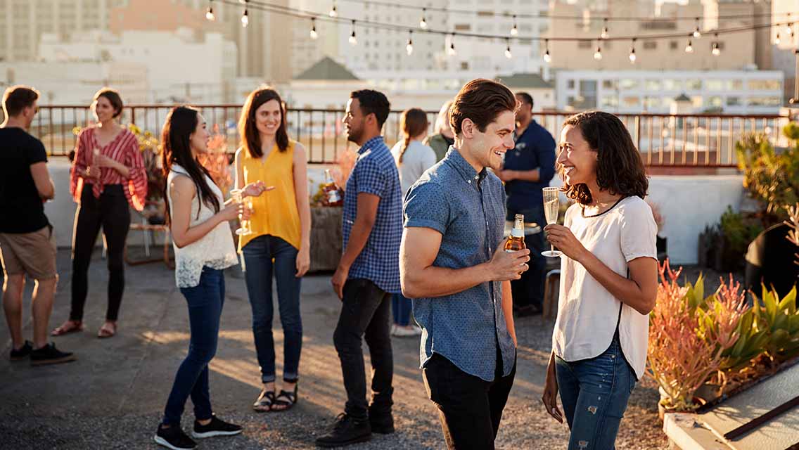 people gather for a rooftop party