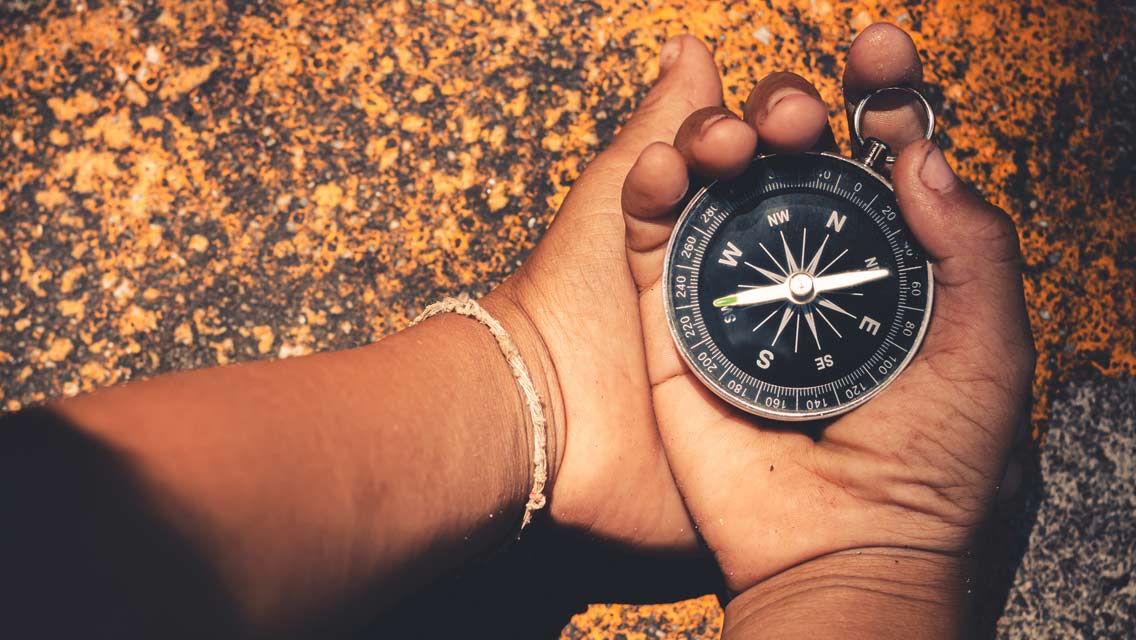 hands hold a compass.