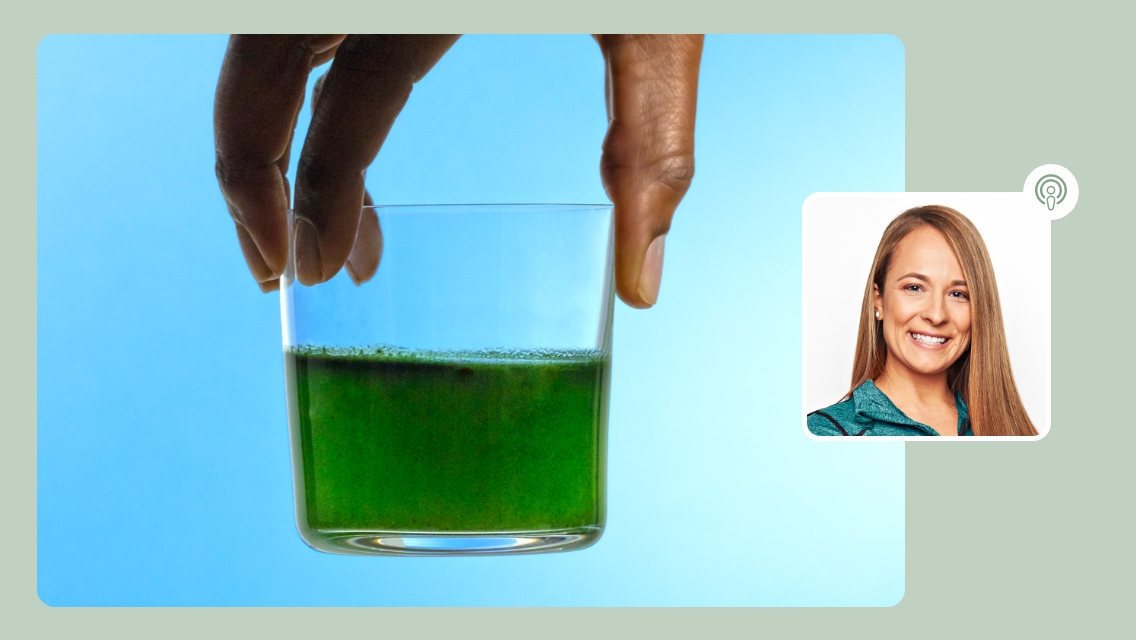 person holding green liquid in cup