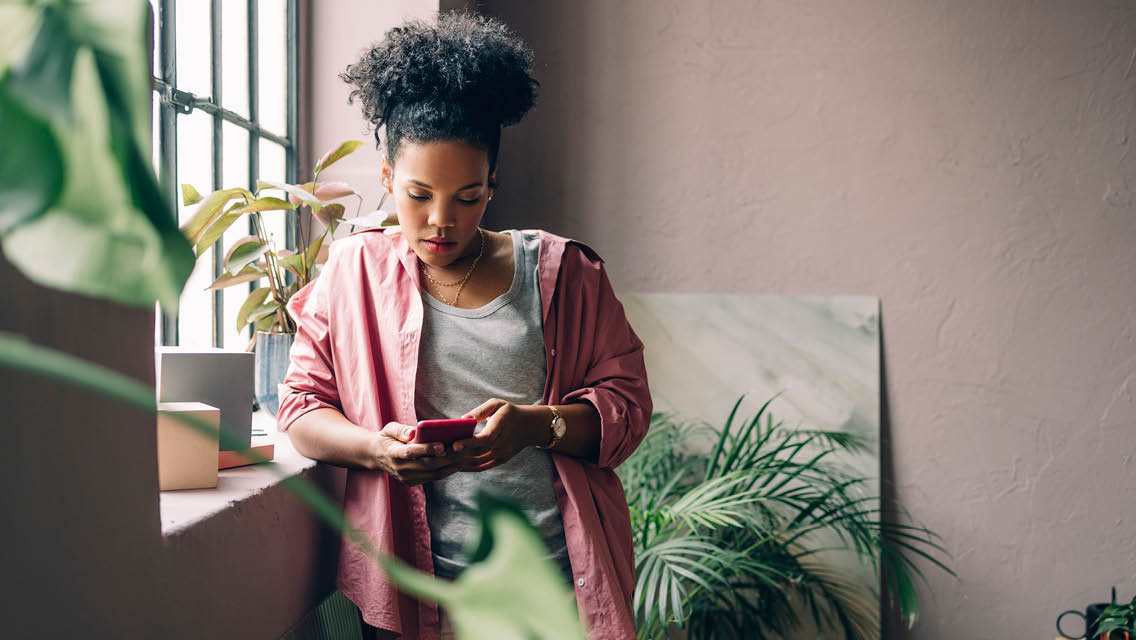 a woman looks on her phone