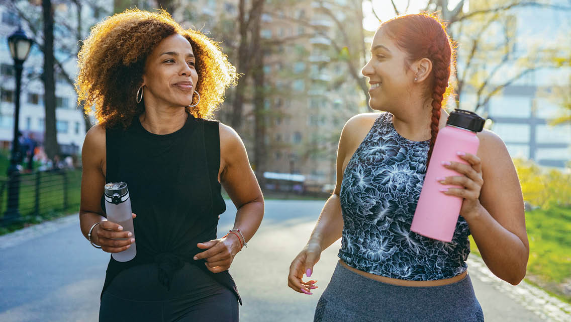 two women power walking