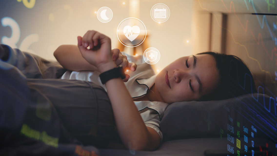 a person looks at their smart watch in bed