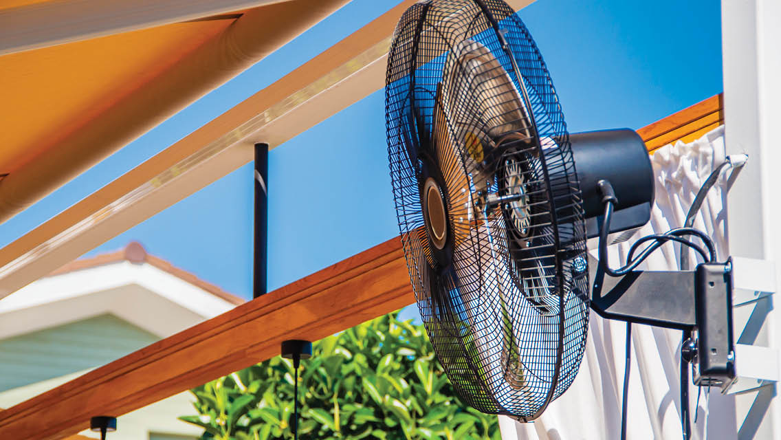 a fan blowing on an outside porch