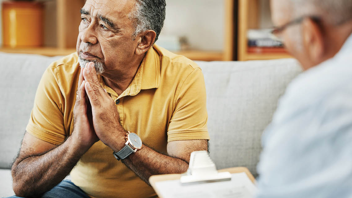 a man looks a way from his therapist