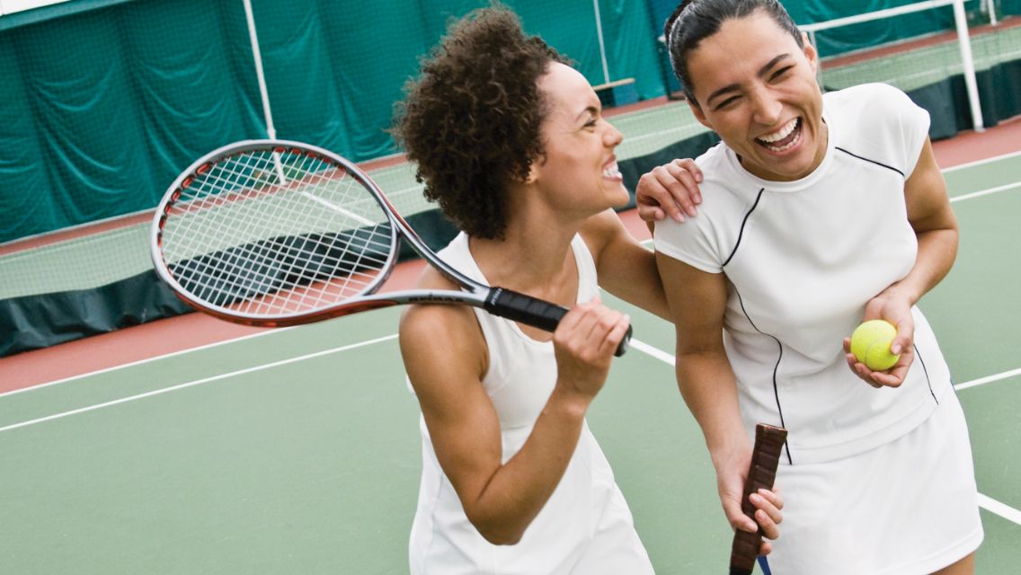 two women playing tennis