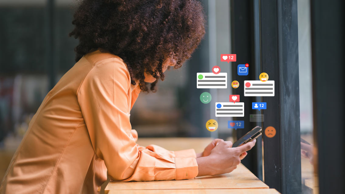 a woman on her phone with social media icons floating above it.