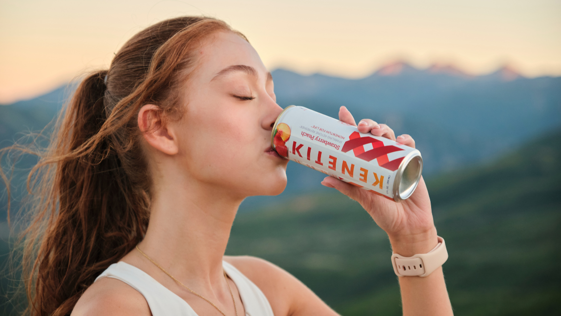 a woman drinks Kenetik.